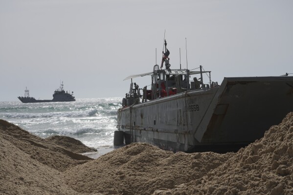 FILE - A U.S. Army landing craft is seen beached in Ashdod, May 26, 2024, after being swept by wind and current from the temporary humanitarian pier in the Gaza Strip. A key section of the U.S. military-built pier designed to carry badly needed aid into Gaza by boat has been reconnected to the Gaza beach following storm damage repairs and aid will begin to flow soon, the U.S. Central Command announced Friday. (AP Photo/Tsafrir Abayov, File)