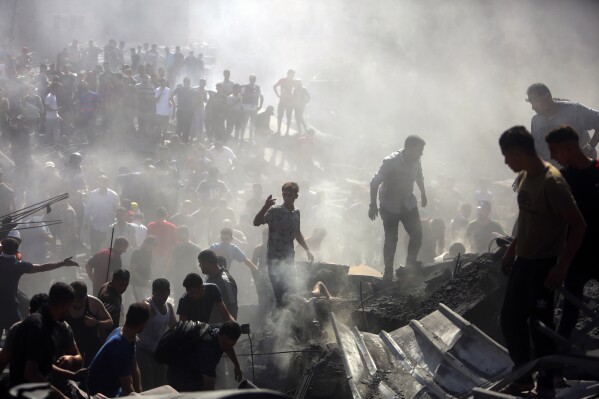 Palestinians inspect the rubble of destroyed buildings following Israeli airstrikes on the town of Khan Younis, southern Gaza Strip, on Oct. 26, 2023. (AP Photo/Mohammed Dahman)