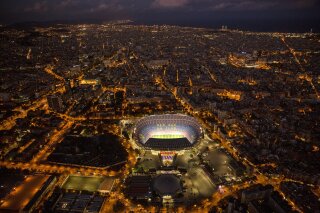 FILE - In this Tuesday, Sept. 19, 2017 file photo, the Camp Nou stadium is illuminated in Barcelona, Spain. All upcoming professional soccer games in Spain, France and Portugal, as well as some in Germany and a European Championship qualifying match in Slovakia, will be played in empty stadiums because of the coronavirus outbreak. For most people, the new coronavirus causes only mild or moderate symptoms, such as fever and cough. For some, especially older adults and people with existing health problems, it can cause more severe illness, including pneumonia. (AP Photo/Emilio Morenatti)