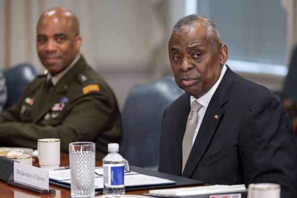 Secretary of Defense Lloyd Austin, right, speaks during a meeting with Latvian Defense Minister Andris Spruds, not pictured, at the Pentagon on Thursday, March 14, 2024, in Washington. (AP Photo/Kevin Wolf)