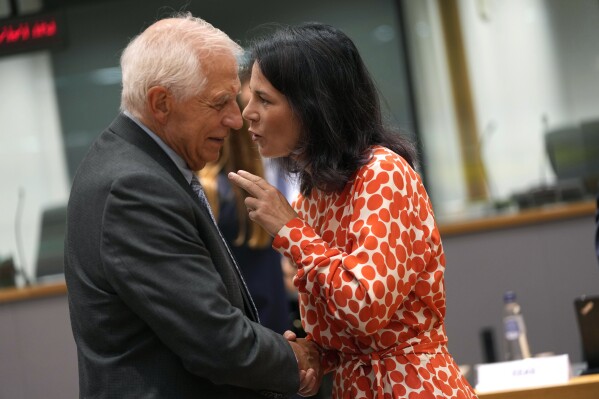 Germany's Foreign Minister Annalena Baerbock, right, speaks with European Union foreign policy chief Josep Borrell during a meeting of EU foreign ministers at the European Council building in Brussels, Thursday, Aug. 29, 2024. (AP Photo/Virginia Mayo)