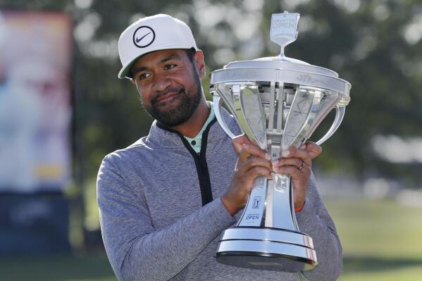 Tony Finau holds up the trophy at the end of the final round after winning the Houston Open golf tournament Sunday, Nov. 13, 2022, in Houston. (AP Photo/Michael Wyke)