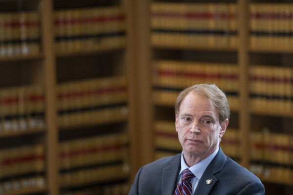 Oregon Senate Republican Leader Sen. Tim Knopp listens during a news conference as part of a 2024 legislative preview at the State Library on Wednesday, Jan. 31, 2024, in Salem, Ore. The Oregon Supreme Court said Thursday, Feb. 1, 2024, that 10 Republican state senators who staged a record-long walkout last year to stall bills on abortion, transgender health care and gun rights cannot run for reelection. (AP Photo/Jenny Kane)