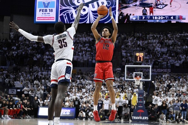 St. John's guard RJ Luis Jr. (12) goes up to shoot over UConn center Samson Johnson (35) in the first half of an NCAA college basketball game, Friday, Feb. 7, 2025, in Storrs, Conn. (AP Photo/Jessica Hill)