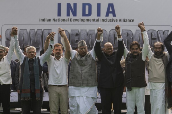 FILE- Leaders from the opposition INDIA alliance raise their hands together in a show of unity during a protest rally against the suspension of more than 140 lawmakers from the parliament, in New Delhi, India, Dec. 22, 2023. Last year more than two dozen opposition parties in India came together to take on Narendra Modi, one of the country's most popular prime ministers in generations. But the broad alliance, beset with ideological differences and personality clashes, is cracking at a crucial time, just months before the country votes in a national election. (AP Photo/Altaf Qadri, File)