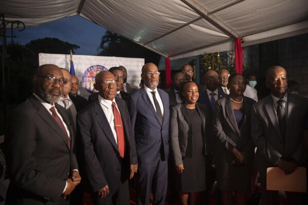Haiti's Prime Minister Ariel Henry, center, poses for a group photo with the new members of his cabinet, in Port-au-Prince, Haiti, Wednesday, Nov. 24, 2021. (AP Photo/Odelyn Joseph)