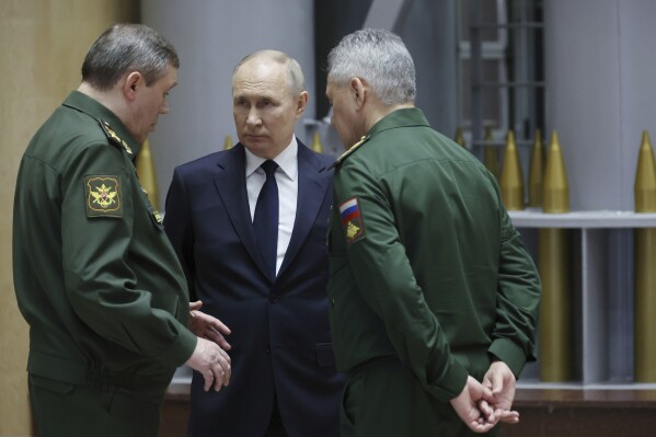 FILE - Russian President Vladimir Putin, center, talks with Russian Chief of General Staff Gen. Valery Gerasimov, left, and Russian Defense Minister Sergei Shoigu after a meeting with military leaders in Moscow, Russia, Tuesday, Dec. 19, 2023. Putin has cast the conflict in Ukraine as a life-or-death battle against the West, with Moscow ready to protect its gains at any cost. (Mikhail Klimentyev, Sputnik, Kremlin Pool Photo via AP, File)