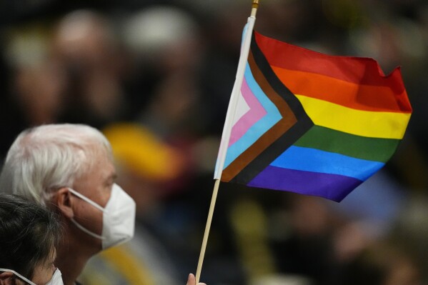 FILE - A fan holds a flag on Gay Pride night in the second half of an NCAA college basketball game, Feb. 9, 2024, in Boulder, Colo. Dozens of health officials, civil rights groups, individuals and businesses have weighed in about how the U.S. Census Bureau should ask about sexual orientation and gender identity for the first time on its most comprehensive survey of American life. An Associated Press review of the 91 written public comments posted in January 2024 shows them to be largely supportive of the proposed additions, though not without constructive criticism. (AP Photo/David Zalubowski, File)