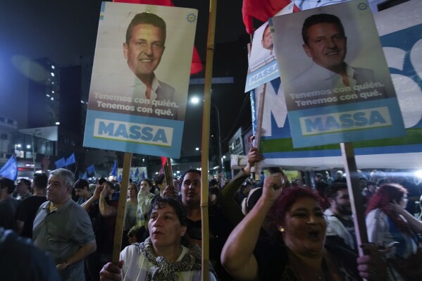 Supporters of Sergio Massa, Economy Minister and presidential candidate for the ruling party, gather outside his campaign headquarters after polls closed for general elections in Buenos Aires, Argentina, Sunday, Oct. 22, 2023. Massa held the lead in early results and is poised to face off anti-establishment candidate Javier Milei in a second round on Nov. 19. (AP Photo/Mario De Fina)