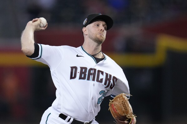 Arizona Diamondbacks starting pitcher Merrill Kelly throws against the San Francisco Giants during the first inning of a baseball game Wednesday, Sept. 20, 2023, in Phoenix. (AP Photo/Ross D. Franklin)