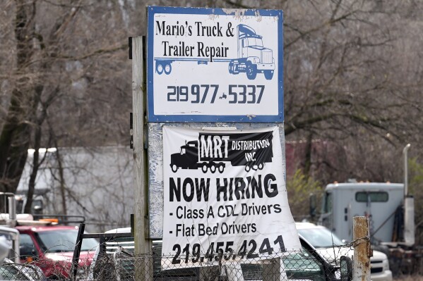 A sign seeking truck drivers is displayed at a business in Gary, Ind., Tuesday, March 26, 2024. On Thursday, April 4, 2024, the Labor Department reports on the number of people who applied for unemployment benefits last week. (AP Photo/Nam Y. Huh)