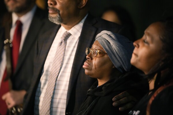 A tear runs down Shinean McClain's cheek as she is comforted by Omar Montgomery, president of the Aurora NAACP, outside the Adams County Colorado Justice Center following her sentencing for the murder of her son Elijah McClain, Friday, Dec. 22, 2023 ., in Brighton, Colo. Two paramedics were convicted in the 2019 killing of McClain, who was given an overdose of the sedative ketamine after police grabbed him by the neck.  (AP Photo/David Zalubowski)