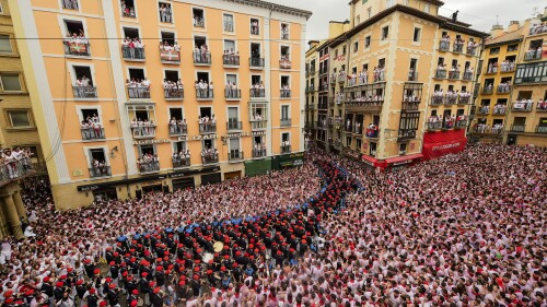 A music band plays in the town hall square after the 'Chupinazo' rocket, to mark the official opening of the 2023 San Fermín fiestas in Pamplona, Spain, Thursday, July 6, 2023. (AP Photo/Alvaro Barrientos)