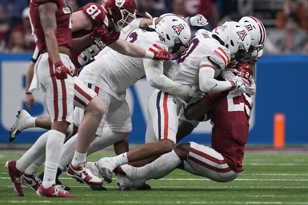 Oklahoma running back Tawee Walker (29) is stopped by Arizona on a run during the second half of the Alamo Bowl NCAA college football game in San Antonio, Thursday, Dec. 28, 2023. (AP Photo/Eric Gay)
