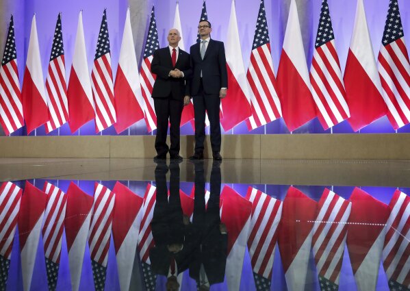 
              United States Vice President Mike Pence, left, and Poland's Prime Minister Mateusz Morawiecki, right, shake hands prior to a meeting at the Chacellery in Warsaw, Poland, Thursday, Fe...