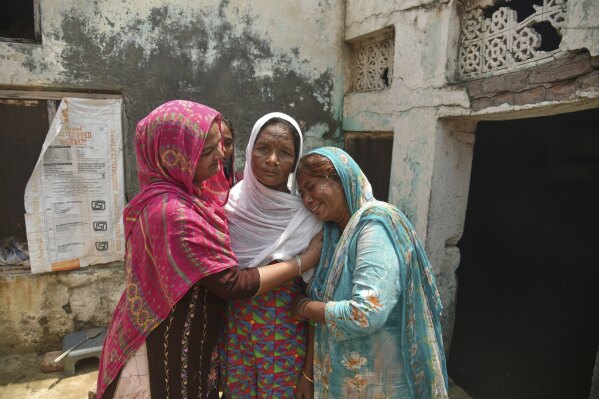 CORRECT NAME OF THE VICTIM-Family members of Major Singh who died after consuming toxic liquor in Majitha village wail on the outskirts of Amritsar, India, Tuesday, May 13. 2025. (AP Photo/Prabhjot Gill)