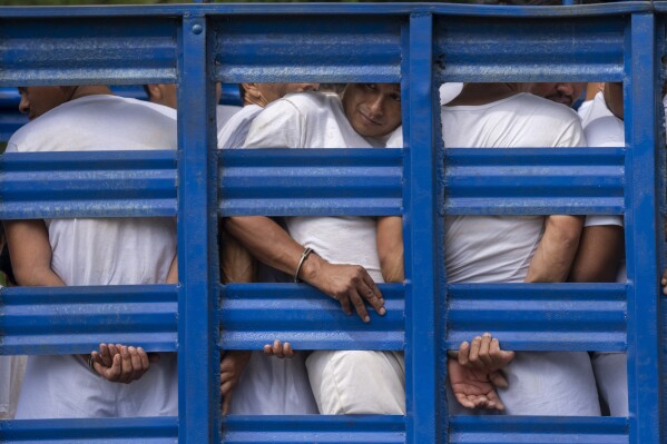 FILE - Men detained under a state of emergency are transported to a detention center in a cargo truck, in Soyapango, El Salvador, Friday, Oct. 7, 2022. Lawmakers on Friday, March 8, 2024, granted a request by President Nayib Bukele for the 24th consecutive one-month extension of an anti-gang emergency decree. (AP Photo/Moises Castillo, File)