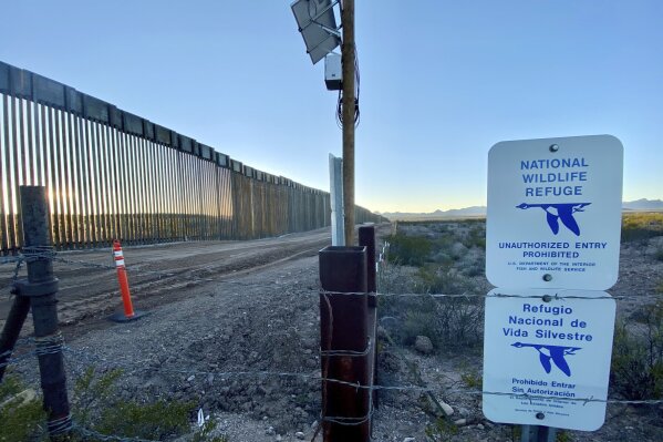 In this January 2020, photo provided by the Center for Biological Diversity, is the border wall near the wetlands at the San Bernardino National Wildlife Refuge in southeastern Arizona. The federal agency in charge of the refuge warned for several months that pumping water to build a border wall would decimate the habitat, and correspondence obtained by two environmental groups shows that U.S. Customs and Border Protection ignored most of those warnings and pulled water from wells so close to the refuge that some of its ponds went dry. (Laiken Jordahl/Center for Biological Diversity via AP)