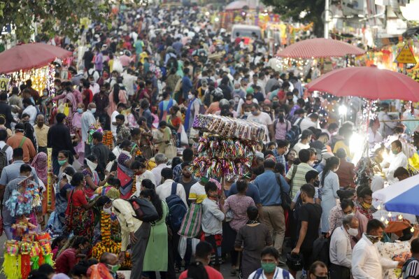 People crowd a market place for Diwali festival shopping in Mumbai, India, Thursday, Nov. 12, 2020. India's tally of coronavirus cases is currently the second largest in the world behind the United States. The government warns that the situation can worsen due to people crowding markets for festival shopping. (AP Photo/Rajanish Kakade)