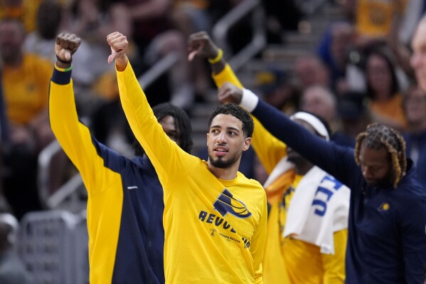Indiana Pacers guard Tyrese Haliburton celebrates on the bench during the second half of Game 4 against the New York Knicks in an NBA basketball second-round playoff series, Sunday, May 12, 2024, in Indianapolis. (AP Photo/Michael Conroy)