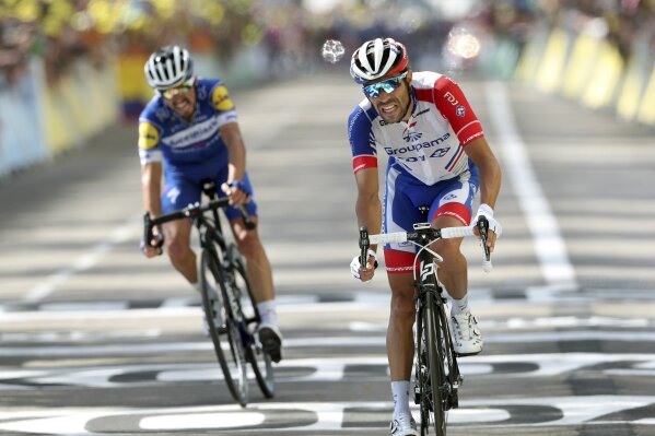 France's Thibaut Pinot, right, and France's Julian Alaphilippe crosse the finish line of the eighth stage of the Tour de France cycling race over 200 kilometers (125 miles) with start in Macon and finish in Saint Etienne, France, Saturday, July 13, 2019. (AP Photo/Thibault Camus)