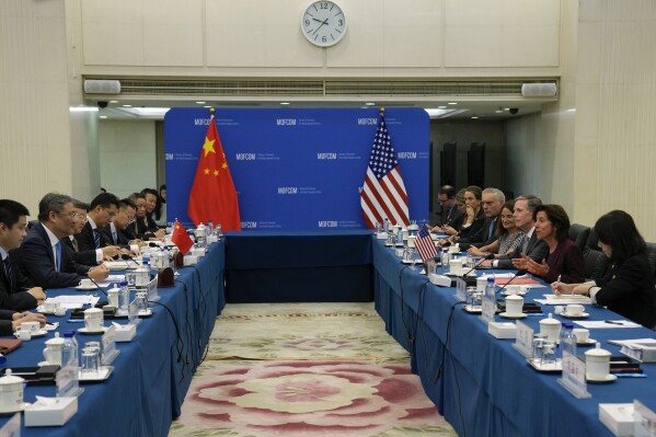 U.S. Commerce Secretary Gina Raimondo, second right, speaks during a meeting with Chinese Minister of Commerce Wang Wentao, second left, at the Ministry of Commerce in Beijing, Monday, Aug. 28, 2023. (AP Photo/Andy Wong, Pool)