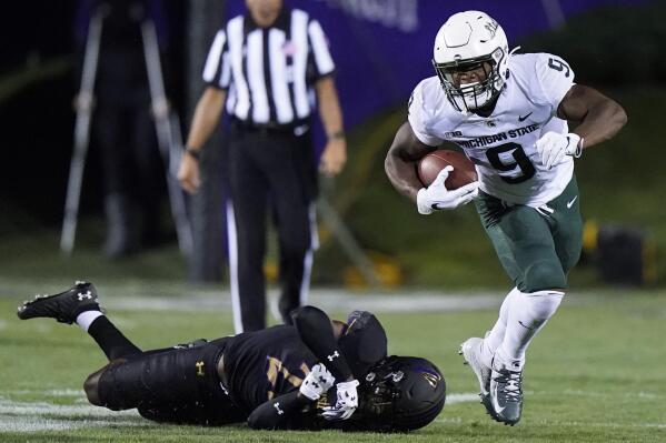 Michigan State running back Kenneth Walker III runs past Northwestern defensive back Bryce Jackson on the way to a touchdown during the first half of an NCAA college football game in Evanston, Ill., Friday, Sept. 3, 2021. (AP Photo/Nam Y. Huh)