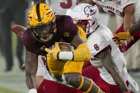 Arizona State running back Rachaad White is tackled by Southern Utah linebacker La'akea Kaho'ohanohano-Davis (8) during the first half of an NCAA college football game, Thursday, Sept. 2, 2021, in Tempe, Ariz. (AP Photo/Matt York)