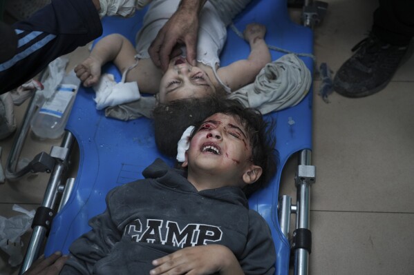 Palestinians wounded in the Israeli bombardment of the Gaza Strip are brought to a hospital in Deir al-Balah on Wednesday, Nov. 15, 2023. (AP Photo/Hatem Moussa