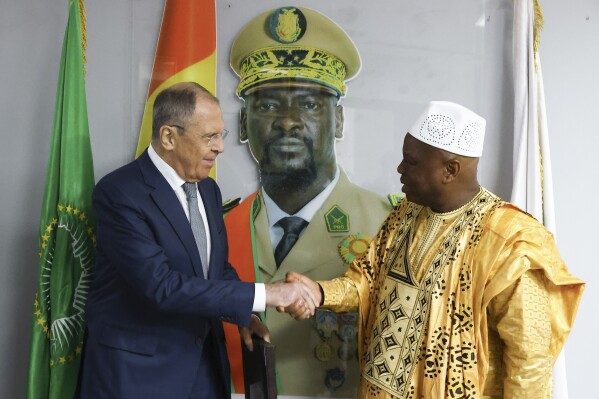 FILE - In this photo released by Russian Foreign Ministry Press Service, Russian Foreign Minister Sergey Lavrov, left, and Guinea's foreign minister Morissanda Kouyate shake hands near a portrait of Guinea's President Mamadi Doumbouya during their meeting in Conakry, Guinea, on June 3, 2024. Lavrov went on a tour of the Sub-Saharan region of the Sahel this week, as Moscow seeks to grow its influence in the restive, mineral-rich region of Africa. (Russian Foreign Ministry Press Service via AP, File)