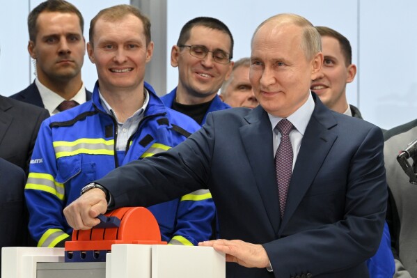 FILE - Russian President Vladimir Putin, foreground right, attends the launch ceremony for the first technological line for liquefying natural gas on gravity bases as part of the Arctic LNG2 (Liquefied Natural Gas) project at the Center for the construction of large-tonnage offshore structures (CSCMS) of Novatek-Murmansk company in the village of Belokamenka, about 1700 km (1063 miles) north of Moscow, Murmansk region, Russia, Thursday, July 20, 2023. The U.S. is sanctioning a newly established UAE company, which provides engineering and technology that Western corporations previously offered, to Russia’s Arctic liquefied natural gas project, as well as multiple Russian companies involved in its development. (Alexander Kazakov, Sputnik, Kremlin Pool Photo via AP, File)