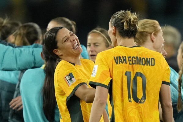 Australia's Sam Kerr laughing with Australia's Emily Van Egmond after winning the Women's World Cup round of 16 soccer match between Australia and Denmark at Stadium Australia in Sydney, Australia, Monday, Aug. 7, 2023. (AP Photo/Rick Rycroft)