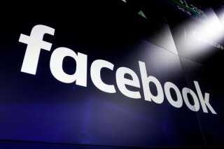 FILE - This March 29, 2018 file photo shows the Facebook logo on screens at the Nasdaq MarketSite, in New York's Times Square. With vaccination against COVID-19 in full swing, social platforms like Facebook, Instagram and Twitter say they’ve stepped up their fight against misinformation that aims to undermine trust in the vaccines. But problems abound. For years, the same platforms have allowed anti-vaccination propaganda to flourish, making it difficult to stamp out such sentiments now. And their efforts to weed out other types of COVID-19 misinformation – often with fact-checks, informational labels and other restrained measures, has been woefully slow. (AP Photo/Richard Drew, File)
