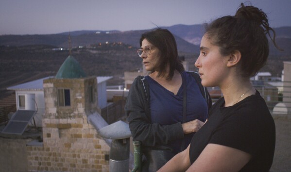 This image released by Beall Productions shows Palestinian actress Hiam Abbass, left, and Lina Soualem in a scene from the documentary "Bye Bye Tiberias." (Frida Marzouk/Beall Productions via AP)