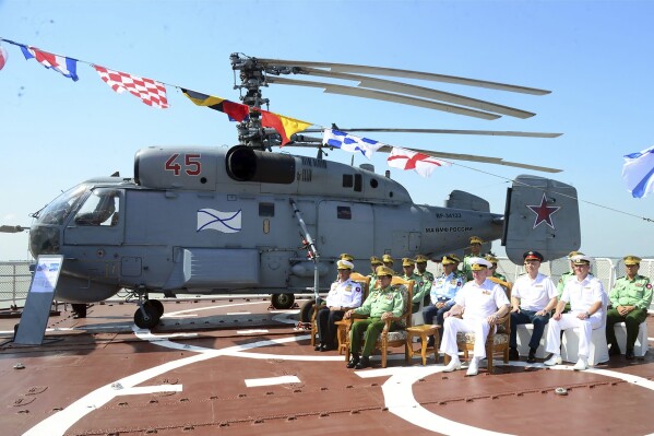 In this photo released from the The Military True News Information Team on Nov. 6, 2023, Senior Gen. Min Aung Hlaing, center, leader of ruling military council, attends together with Russian Navy Commander-in-chief Admiral Nikolai Yevmenov, center right, during opening ceremony of first Myanmar Russia Maritime Security Exercise at Thilawa port in Yangon, Myanmar. (The Military True News Information Team via AP)