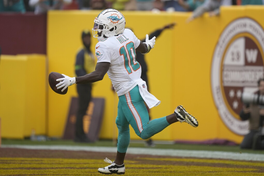 Miami Dolphins wide receiver Tyreek Hill (10) celebrates after scoring against the Washington Commanders during the first half of an NFL football game Sunday, Dec. 3, 2023, in Landover, Md. (APPhoto/Mark Schiefelbein)