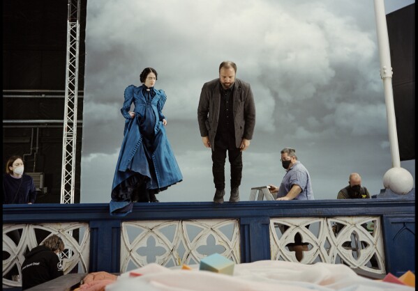 This image released by Searchlight Pictures shows Emma Stone and Yorgos Lanthimo on the set of 