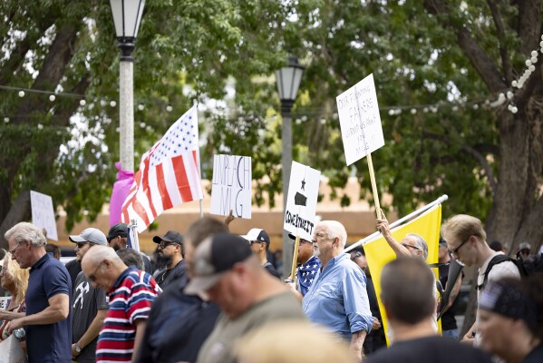A large group of people gathered at Old Town Plaza in Albuquerque, N.M. on Sunday, Sept.10, 2023, to protest New Mexico Gov. Michelle Lujan Grisham's recent emergency order suspending the carrying of concealed and open firearms. (Gino Gutierrez/The Albuquerque Journal via AP)