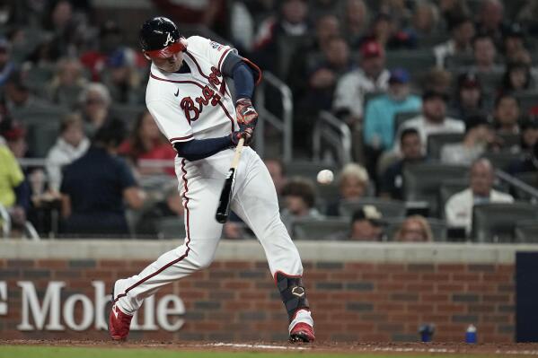 Austin Riley of the Atlanta Braves hits an RBI single in the sixth inning  of Game 4 of the World Series against the Houston Astros on Oct. 30, 2021,  at Truist Park