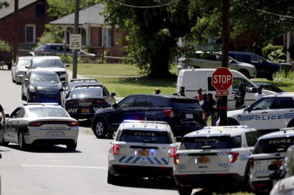Multiple law enforcement vehicles respond in the neighborhood where several officers on a task force trying to serve a warrant were shot in Charlotte, N.C., Monday, April 29, 2024. (Khadejeh Nikouyeh/The Charlotte Observer via AP)