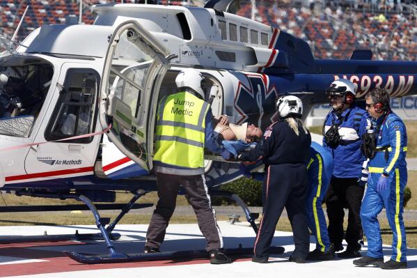 Driver Jordan Anderson is loaded into a helicopter after a fiery crash during the NASCAR Trucks Chevrolet Silverado 250 auto race, Saturday, Oct. 1, 2022, in Talladega, Ala. (AP Photo/Butch Dill)