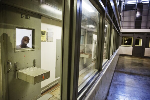 FILE - An inmate looks out of his cell in the the Special Management Unit, known as high-max at the Georgia Diagnostic and Classification Prison, Dec. 1, 2015, in Jackson, Ga. The Special Management Unit of the Georgia Diagnostic and Classification Prison houses some of the state’s most violent offenders. In a damning ruling, U.S. District Judge Marc Treadwell said Friday, April 19, 2024, that prison officials showed no desire or intention to make the required changes to SMU's solitary confinement practices. (AP Photo/David Goldman, File)
