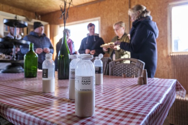 Buttermilk and other products sit on the table at the shop at the Floating Farm on Nov. 7 2023, in Rotterdam, Netherlands. The farm’s owners say the extreme weather spurred by climate change — heavy rainfall and flooding of cities and farmland — makes the farm's approach climate-adaptive to feed those cities. (AP Photo/Patrick Post)