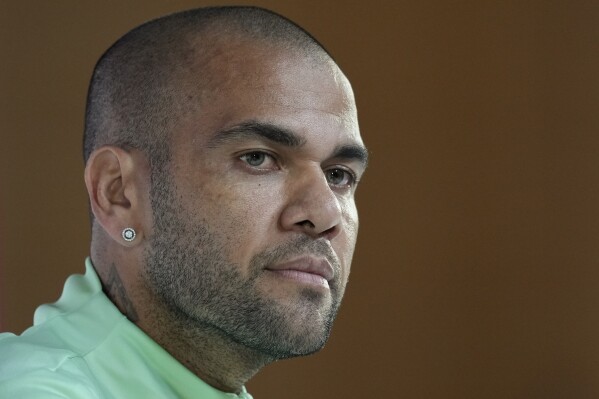 FILE - Brazil's Dani Alves listens to a question during a press conference on the eve of the group G of World Cup soccer match between Brazil and Cameroon in Doha, Qatar, on Dec. 1, 2022. Alves will face trial for allegedly having sexually assaulted a woman in a night club last year, a Spanish judge ordered Tuesday Nov. 14, 2023. (AP Photo/Andre Penner, File)