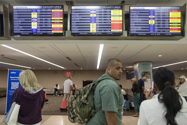 James Rodriguez talks with his wife, Diana, after his flight to Cancun was canceled at Fort Lauderdale-Hollywood International Airport due to heavy rains across South Florida, Wednesday, June 12, 2024, in Fort Lauderdale, Fla.  /AP via Miami Herald)