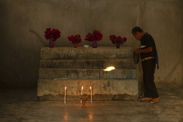Deacon Juan Pérez Gómez prepares the altar for a Sunday Mass, in the Simojovel municipality, Mexico, Saturday, April 26, 2025. (AP Photo/Isabel Mateos)
