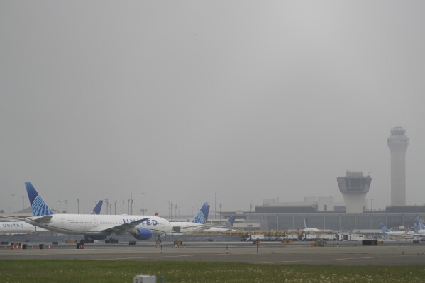 Fog covers planes and control towers at Newark Liberty International Airport in Newark, N.J., Monday, May 5, 2025. (AP Photo/Seth Wenig)
