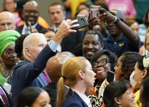 President Joe Biden takes a selfie with members of the audience after speaking during a visit to a mobile COVID-19 vaccination unit at the Green Road Community Center in Raleigh, N.C., Thursday, June 24, 2021. (AP Photo/Susan Walsh)