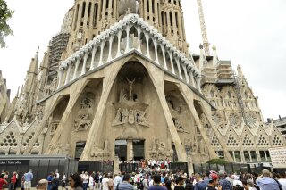 FILE - In this Sunday, Aug. 20, 2017 file photo, dignitaries leave after a Mass at Barcelona's Sagrada Familia Basilica for the victims of the terror attacks, in Barcelona, Spain. Barcelona’s breathtaking La Sagrada Familia Basilica designed by architect Antoni Gaudi has finally received its official construction permit over 130 since the placement of its first stone. Barcelona’s town hall announced on Friday, June 7, 2019 that after negotiations with the church’s builders it had granted them a work permit through 2026. (AP Photo/Manu Fernandez, file)