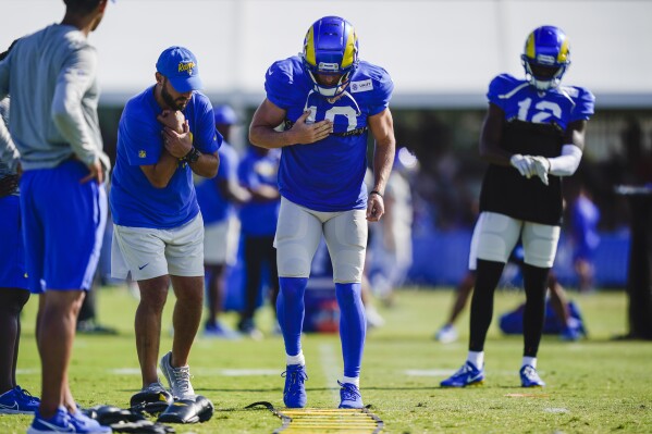 Los Angeles Rams wide receiver Cooper Kupp, center, participates in drills during the NFL football team's training camp, Tuesday, Aug. 1, 2023, in Irvine, Calif. (AP Photo/Ryan Sun)